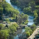 Scenic aerial view of Santa Rosa River flowing through lush greenery in Córdoba, Argentina.