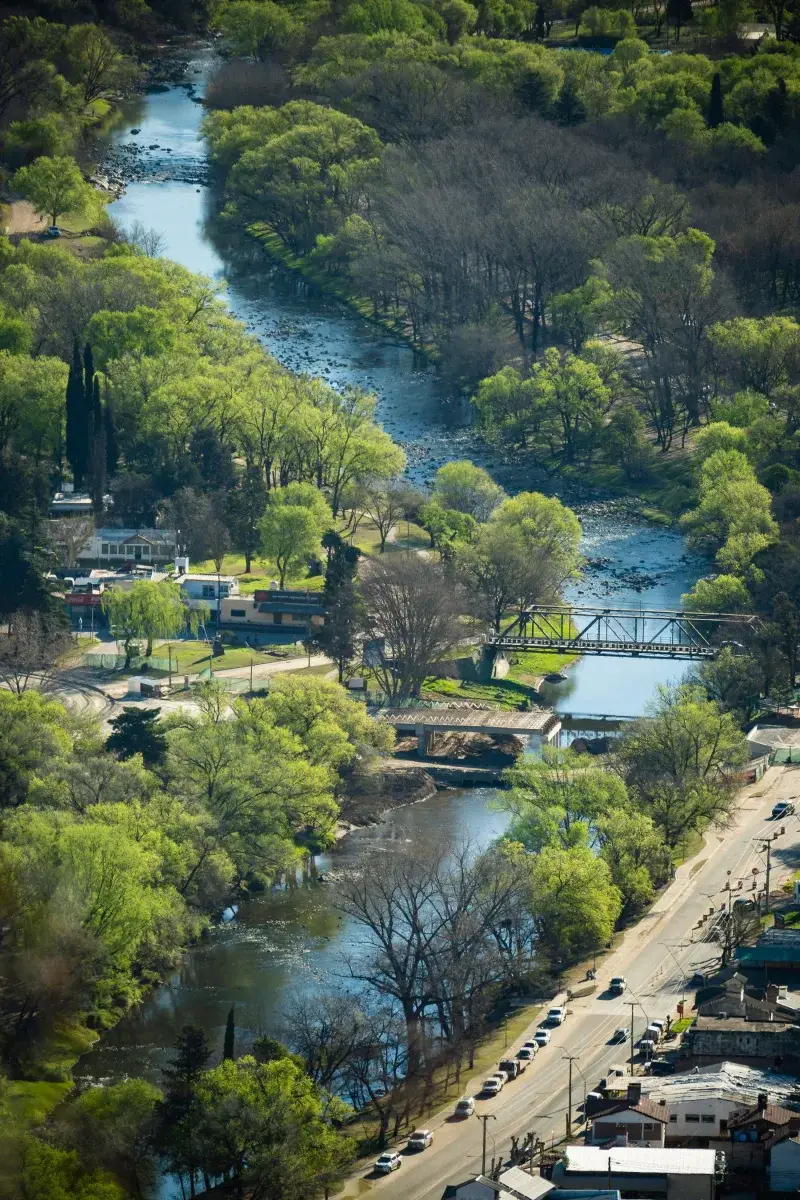 Scenic aerial view of Santa Rosa River flowing through lush greenery in Córdoba, Argentina.