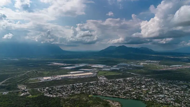 Scenic aerial view of Salinas Victoria, Nuevo León with mountains and clouds.