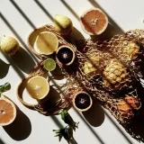 Overhead view of sliced citrus on a white table