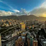 Breathtaking aerial view of Caracas, Venezuela amidst mountains during sunset.
