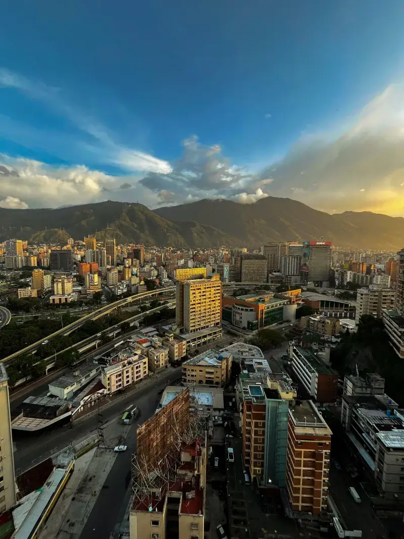 Breathtaking aerial view of Caracas, Venezuela amidst mountains during sunset.