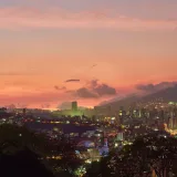 A breathtaking view of Caracas skyline at twilight with a vivid sunset backdrop.