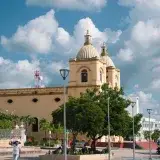 Scenic view of a Catholic church in Corozal, Colombia under a bright blue sky.