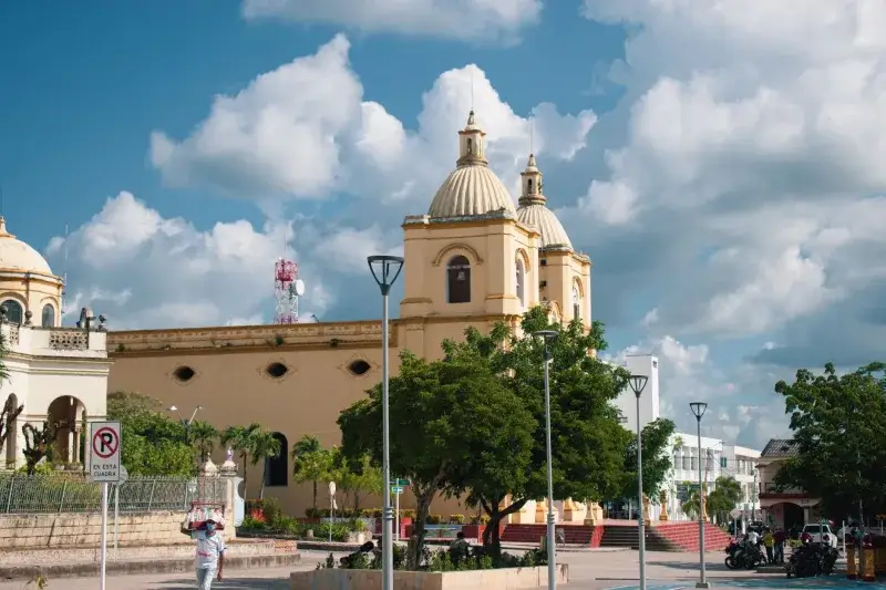 Scenic view of a Catholic church in Corozal, Colombia under a bright blue sky.