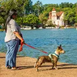 Woman with her dog enjoying a sunny day by Palermo Lake in Buenos Aires, Argentina.