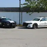 Two service vehicles, Policía Federal and Guardia Nacional, parked in an empty lot.