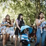 Groups gather outdoors in Buenos Aires, embracing festive community spirit.