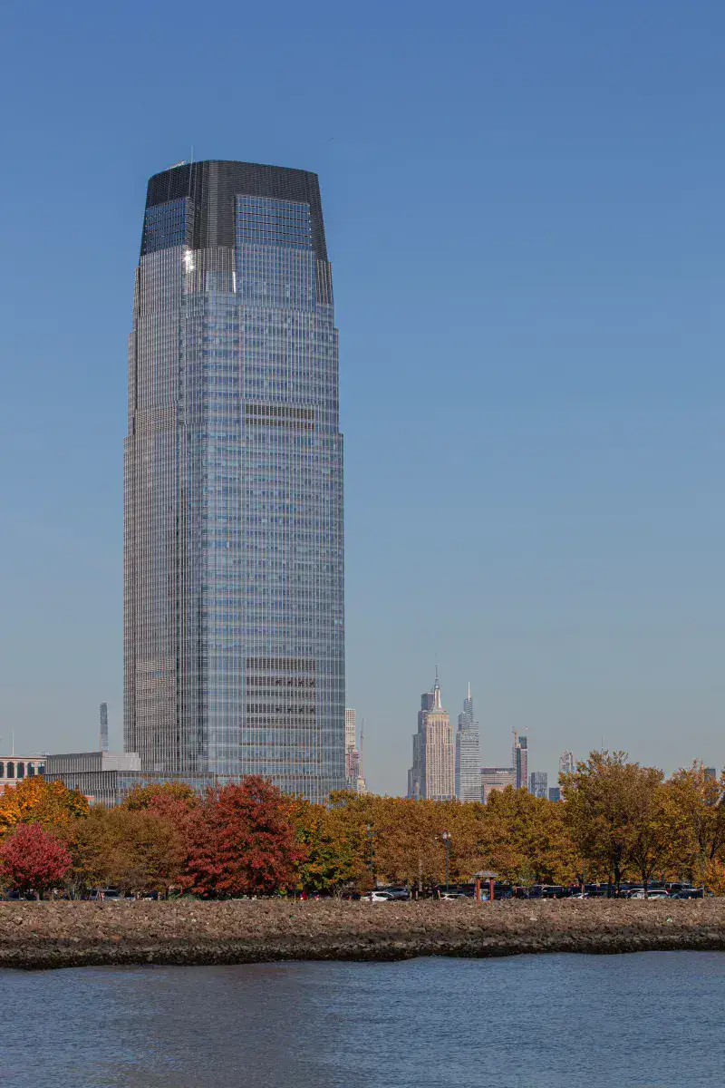 The iconic Goldman Sachs Tower with autumn foliage in Jersey City, New Jersey.