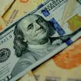 Detailed image of U.S. dollar and Argentine pesos banknotes highlighting currency exchange.