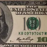 Detailed close-up image of a US one hundred dollar bill showing Benjamin Franklin.