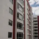Vertical shot of a modern residential building in Mérida, Venezuela, showcasing urban architecture.