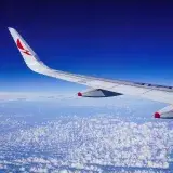 Stunning aerial view of an Avianca airplane wing above clouds during flight over Colombia.