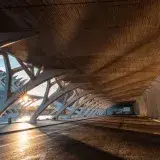Sunset casts dramatic shadows under modern architecture in Valencia, Spain.