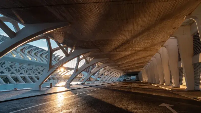 Sunset casts dramatic shadows under modern architecture in Valencia, Spain.