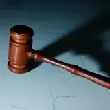 a wooden judge's hammer sitting on top of a table