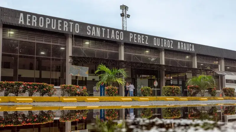 Exterior view of Santiago Perez Quiroz Airport in Arauca, Colombia, with reflection in a puddle.