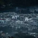 A stunning aerial view of Santa Cruz del Quiché, capturing its urban sprawl and surrounding landscape at dusk.