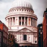 A striking view of St. Paul's Cathedral amidst London's urban landscape, showcasing its iconic dome and architecture.