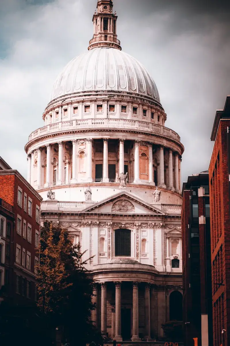 A striking view of St. Paul's Cathedral amidst London's urban landscape, showcasing its iconic dome and architecture.