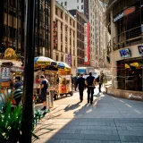 Bustling street vendors and pedestrians in iconic Times Square, New York City.