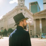 A man with a hat and beard exploring the streets of Buenos Aires, Argentina, on a sunny day.