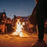 A dynamic protest scene at night in Mexico City, highlighting empowerment and urban activism.