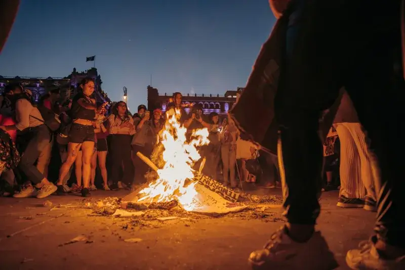 A dynamic protest scene at night in Mexico City, highlighting empowerment and urban activism.