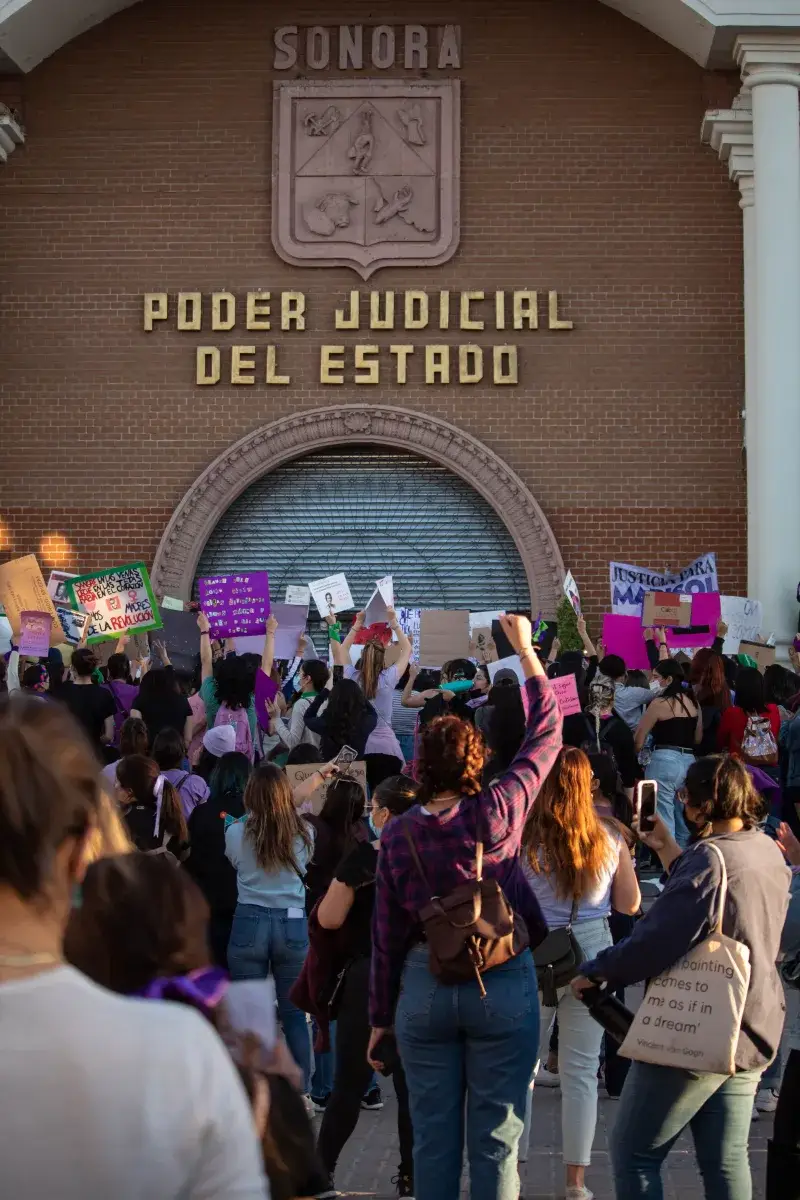 Activists gathering at Sonora State Courthouse for women's rights protest. Raising placards, advocating for justice.