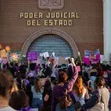 Activists gathering at Sonora State Courthouse for women's rights protest. Raising placards, advocating for justice.