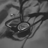 a black and white photo of a stethoscope on a bed