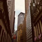 A captivating view of New York City's Wall Street, showcasing iconic architecture and urban density.