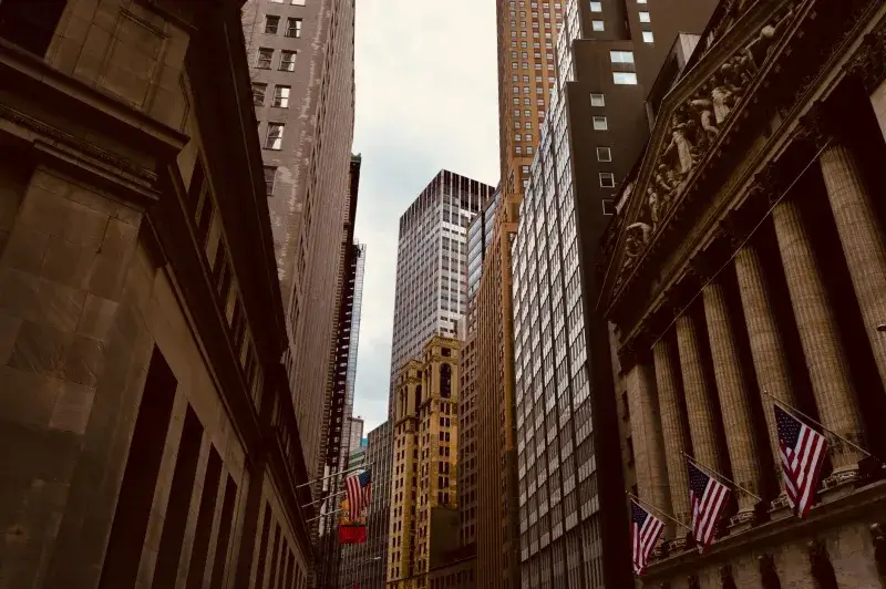 A captivating view of New York City's Wall Street, showcasing iconic architecture and urban density.
