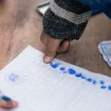 Close-up of fingerprint marking on a voting document in Afghanistan, showing election authentication.