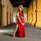 Miss Mexico 2024 contestant in a red gown, standing in a historic Monterrey archway.