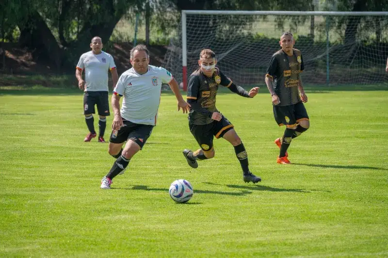 Action-packed amateur soccer match scene with adult players in sportswear on a sunny day.