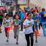 Energetic children participating in a street marathon race in Venezuela.