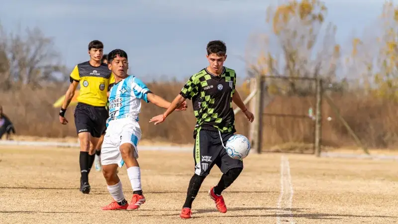 Two young soccer players competing fiercely on the field during a match.