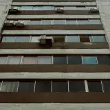 Low angle view of a modern apartment building facade with windows, Mérida, Venezuela.