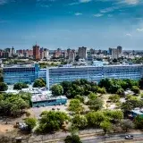 Panoramic view of Maracaibo showing the Rectorate building and city skyline under a clear sky.