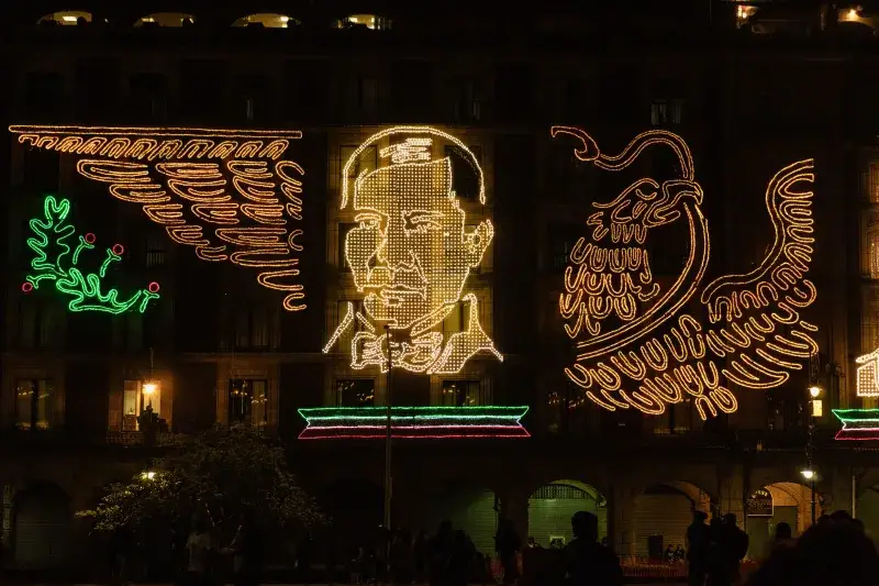 Colorful LED display of patriotic symbols and figures in Mexico City's historic center.