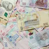 Close-up shot of Ukrainian banknotes featuring various denominations and designs.