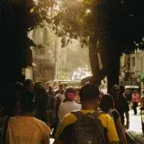 A lively street in Caracas, Venezuela, illuminated by the warm glow of sunset.