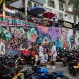 Dynamic street scene featuring colorful graffiti and local culture in Medellín, Colombia.