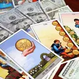 Tarot cards placed on US dollar bills, symbolizing wealth, fortune, and financial divination.