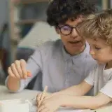 a man and a child are playing with blocks