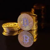 Close-up image of Bitcoin stacks on a reflective surface symbolizing digital currency and wealth.