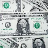 A closeup view of several stacked US dollar bills showcasing currency and financial concepts.