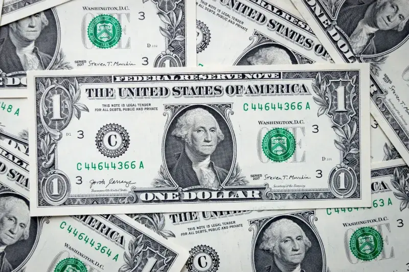 A closeup view of several stacked US dollar bills showcasing currency and financial concepts.