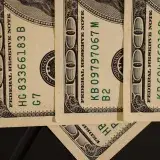 Detailed close-up shot of US dollar bills displaying serial numbers and Federal Reserve details.